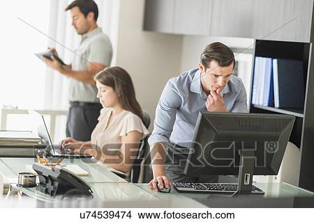 Business people working in office View Large Photo Image Picture - Business people working in office. Fotosearch
