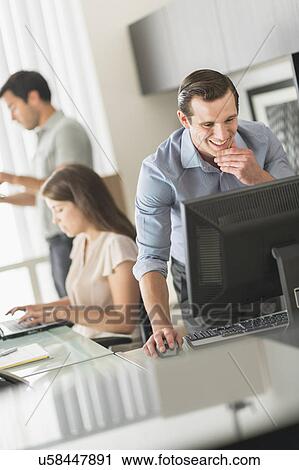 Business people working in office View Large Photo Image Stock Image - Business people working in office. Fotosearch