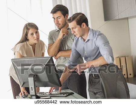 Stock Image - Business people working in office. Fotosearch
