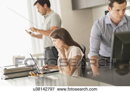 Business people working in office View Large Photo Image Stock Photo - Business people working in office. Fotosearch