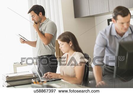 Business people working in office View Large Photo Image Stock Photo - Business people working in office. Fotosearch