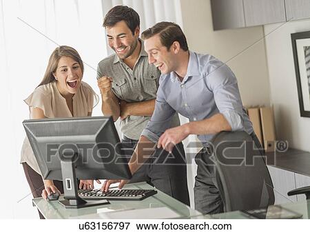 Stock Photo - Business people working in office. Fotosearch