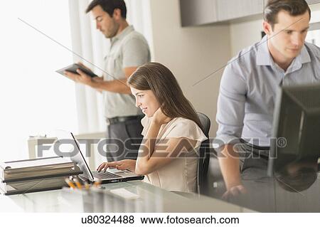 Business people working in office View Large Photo Image Stock Photo - Business people working in office. Fotosearch