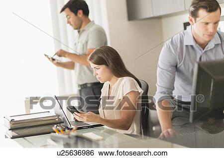 Stock Photograph - Business people working in office. Fotosearch