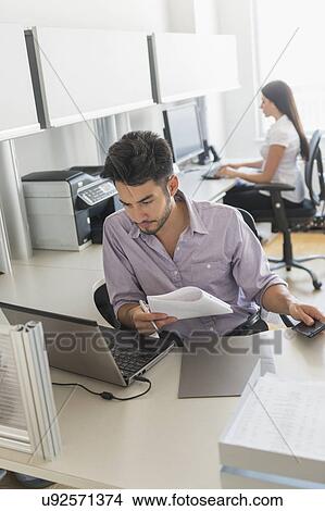 Picture - Businessman at work in office. Fotosearch