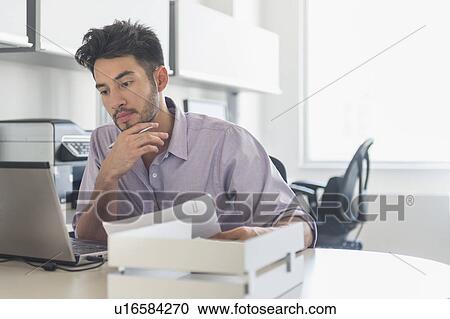 Businessman at work in office View Large Photo Image Stock Image - Businessman at work in office. Fotosearch
