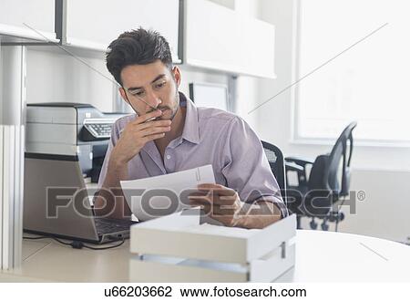 Stock Image - Businessman at work in office. Fotosearch