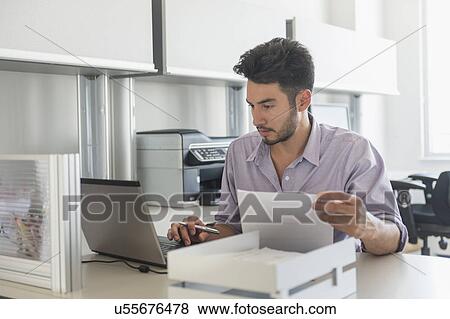 Businessman at work in office View Large Photo Image Stock Photo - Businessman at work in office. Fotosearch