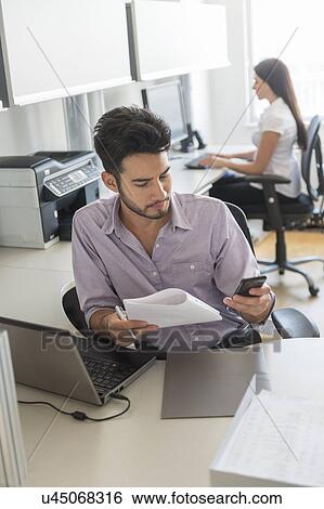 Businessman at work in office View Large Photo Image Stock Photograph - Businessman at work in office. Fotosearch