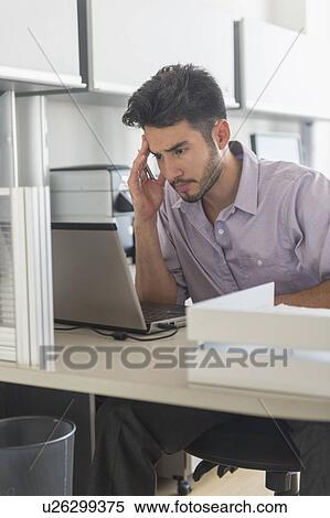 Stock Photography - Businessman at work in office. Fotosearch