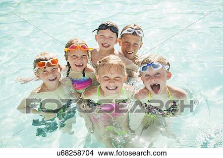Children (4-5, 2-3, 8-9, 10-11, 18-23 months) playing in swimming pool View Large Photo Image Picture - Children (4-5, 2-3, 8-9, 10-11, 18-23 months) playing in swimming pool. Fotosearch