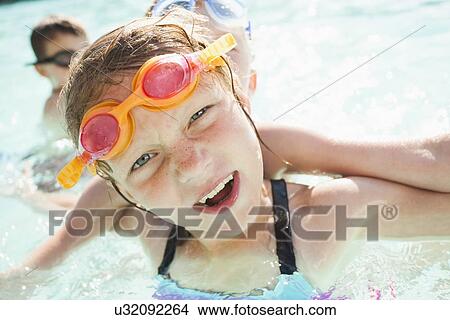Children (4-5, 8-9) playing in swimming pool View Large Photo Image Picture - Children (4-5, 8-9) playing in swimming pool. Fotosearch