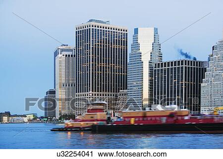 Cityscape at dusk, boats on river View Large Photo Image Stock Image - Cityscape at dusk, boats on river. Fotosearch