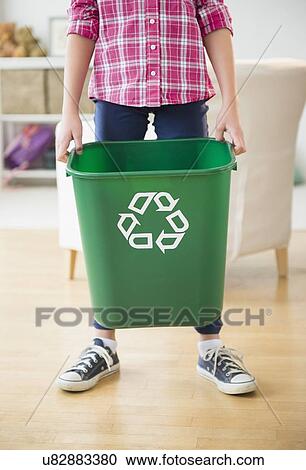 Close up of girl (8-9) holding recycle bin View Large Photo Image Stock Image - Close up of girl (8-9) holding recycle bin. Fotosearch