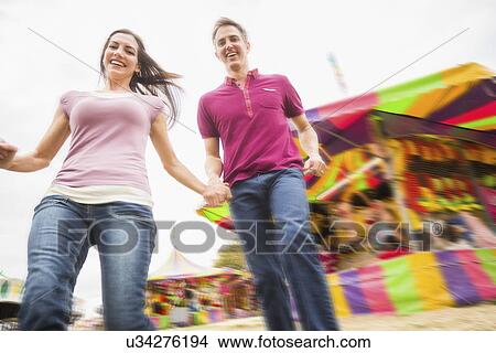 Couple in amusement park View Large Photo Image Picture - Couple in amusement park. Fotosearch