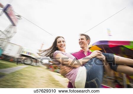 Couple in amusement park View Large Photo Image Stock Image - Couple in amusement park. Fotosearch