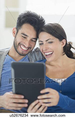 Picture - Couple using digital tablet. Fotosearch
