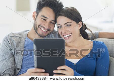 Picture - Couple using digital tablet. Fotosearch