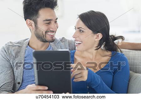 Stock Image - Couple using digital tablet. Fotosearch