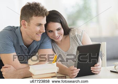Couple using digital tablet View Large Photo Image Stock Photo - Couple using digital tablet. Fotosearch