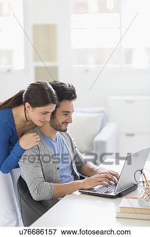 Stock Photo - Couple using laptop. Fotosearch