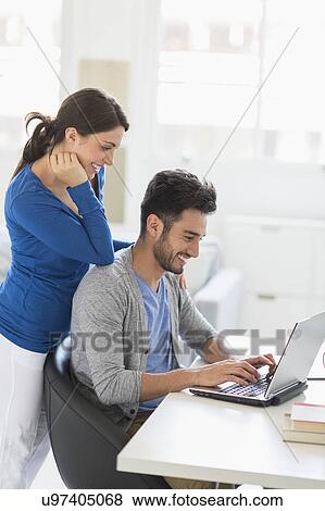 Stock Photo - Couple using laptop. Fotosearch