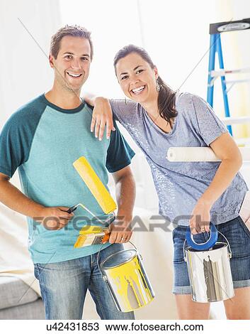Couple with paint rollers View Large Photo Image Stock Image - Couple with paint rollers. Fotosearch
