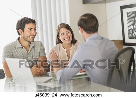 Picture - Customers talking to advisor in office. Fotosearch