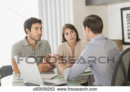 Customers talking to advisor in office View Large Photo Image Stock Image - Customers talking to advisor in office. Fotosearch