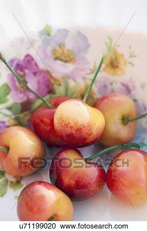 Stock Image - Detail of sour cherries in bowl. Fotosearch