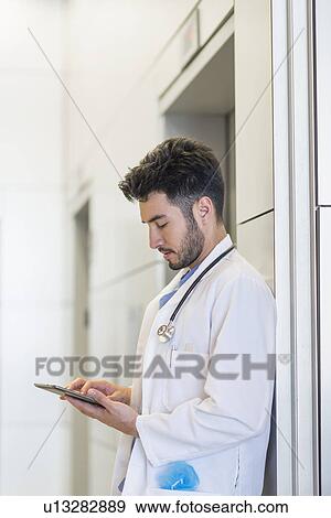 Stock Photo - Doctor using digital tablet in hospital. Fotosearch