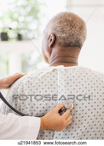 Doctor using stethoscope on patient View Large Photo Image Stock Image - Doctor using stethoscope on patient. Fotosearch