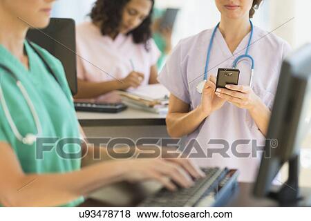 Doctors and nurses working at desks in hospital View Large Photo Image Stock Photo - Doctors and nurses working at desks in hospital. Fotosearch