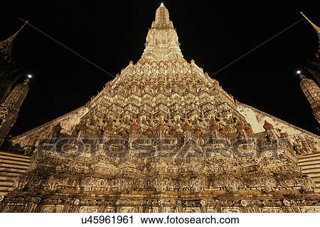 Stock Image - Facade of Wat Arun Temple at night. Fotosearch