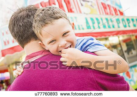 Father and son (4-5) in amusement park View Large Photo Image Stock Image - Father and son (4-5) in amusement park. Fotosearch