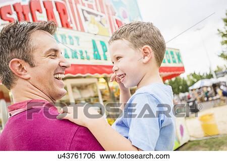 Father and son (4-5) in amusement park View Large Photo Image Stock Photograph - Father and son (4-5) in amusement park. Fotosearch