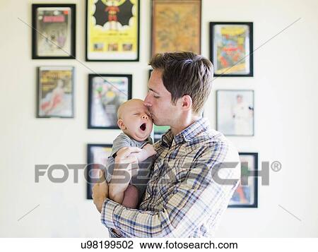 Stock Image - Father kissing baby son (2-5 months). Fotosearch