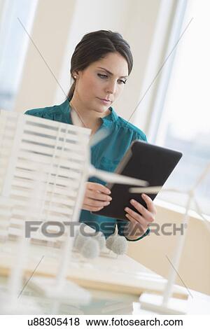 Female architect working in office View Large Photo Image Stock Photo - Female architect working in office. Fotosearch
