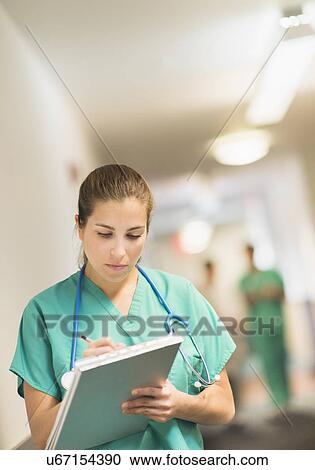 Female doctor in hospital hallway View Large Photo Image Stock Image - Female doctor in hospital hallway. Fotosearch