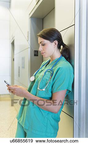 Female doctor text messaging View Large Photo Image Stock Photo - Female doctor text messaging. Fotosearch
