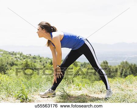 Female jogger stretching View Large Photo Image Stock Photograph - Female jogger stretching. Fotosearch
