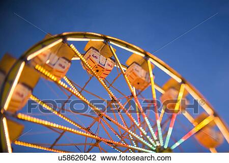 Ferris wheel in amusement park at dusk View Large Photo Image Stock Image - Ferris wheel in amusement park at dusk. Fotosearch