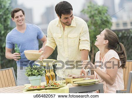 Friends enjoying barbecue in garden View Large Photo Image Stock Photo - Friends enjoying barbecue in garden. Fotosearch