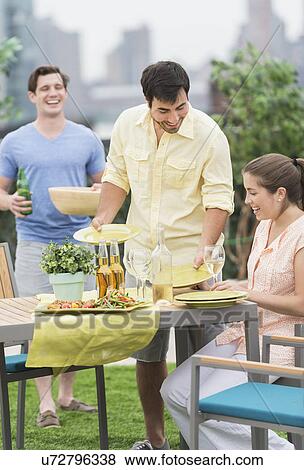 Friends enjoying barbecue in garden View Large Photo Image Stock Photo - Friends enjoying barbecue in garden. Fotosearch