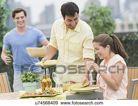 Friends enjoying barbecue in garden View Large Photo Image Stock Photo - Friends enjoying barbecue in garden. Fotosearch