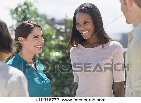 Stock Image - Friends laughing outside. Fotosearch