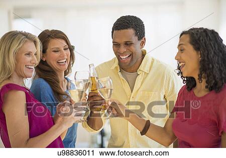 Friends making toast at party View Large Photo Image Stock Image - Friends making toast at party. Fotosearch