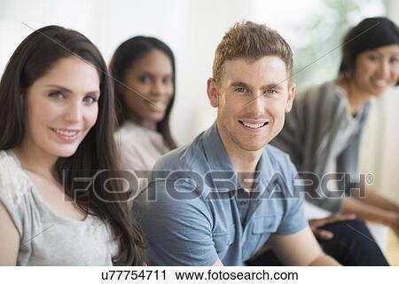 Friends sitting on sofa View Large Photo Image Stock Image - Friends sitting on sofa. Fotosearch