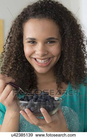 Girl (12-13) holding bowl of black berries View Large Photo Image Stock Photo - Girl (12-13) holding bowl of black berries. Fotosearch