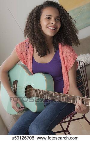 Girl (12-13) playing guitar View Large Photo Image Stock Photo - Girl (12-13) playing guitar. Fotosearch